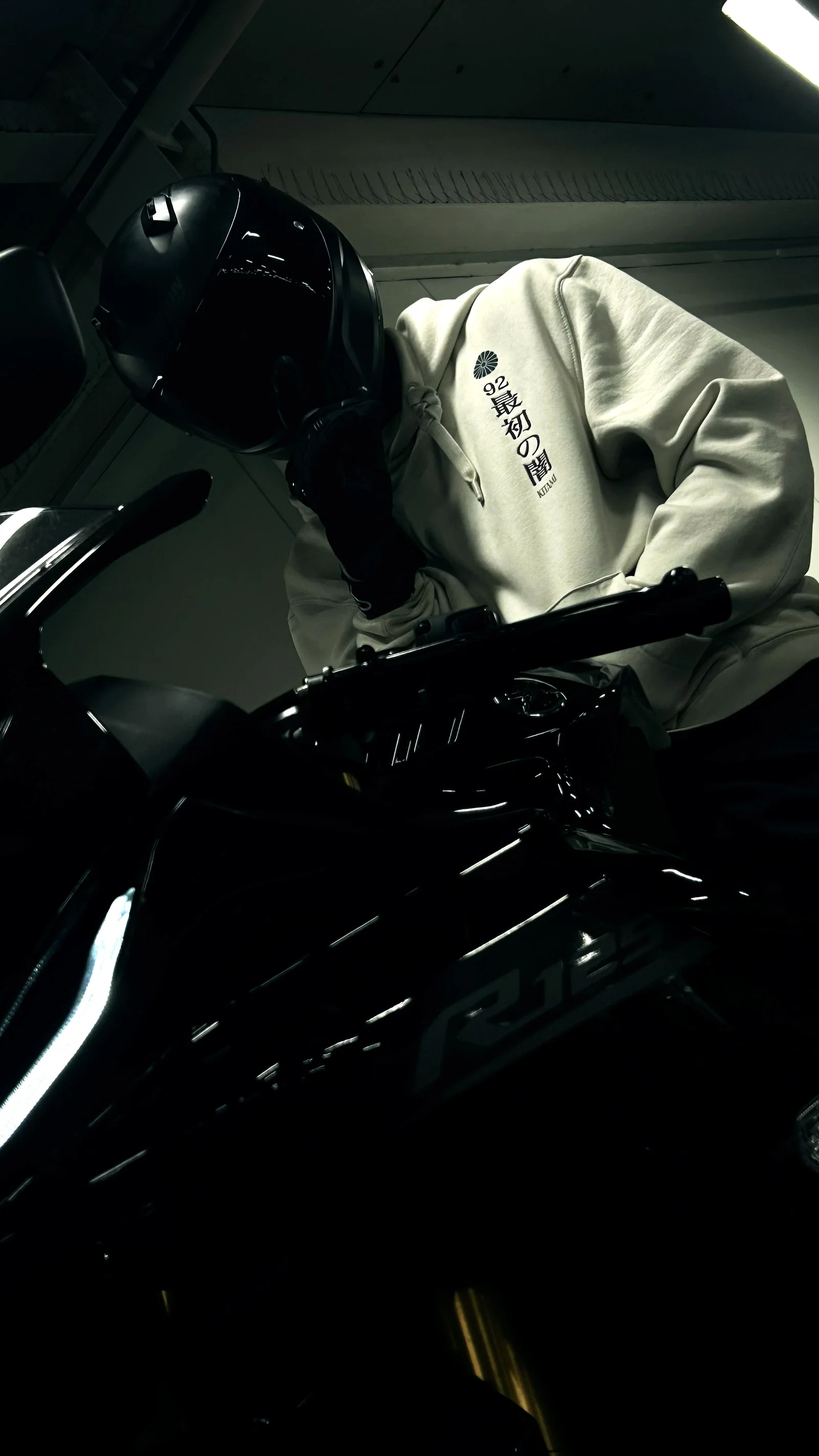 Rider in white hoodie on a motorcycle